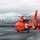Coast Guard MH-65 Dolphin helicopter crews depart Air Station Kodiak, Alaska