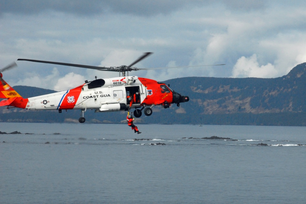 Coast Guard MH-60 Jayhawk helicopter crew completes vertical surface training hoist operation in Kodiak, Alaska