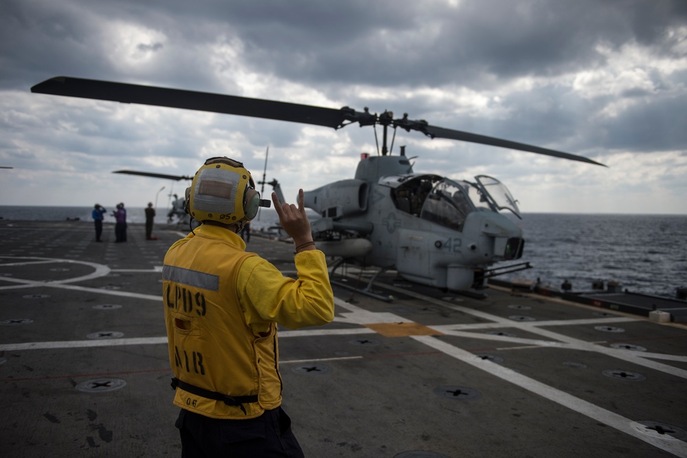 Signaling a AH-1W Super Cobra light attack helicopter