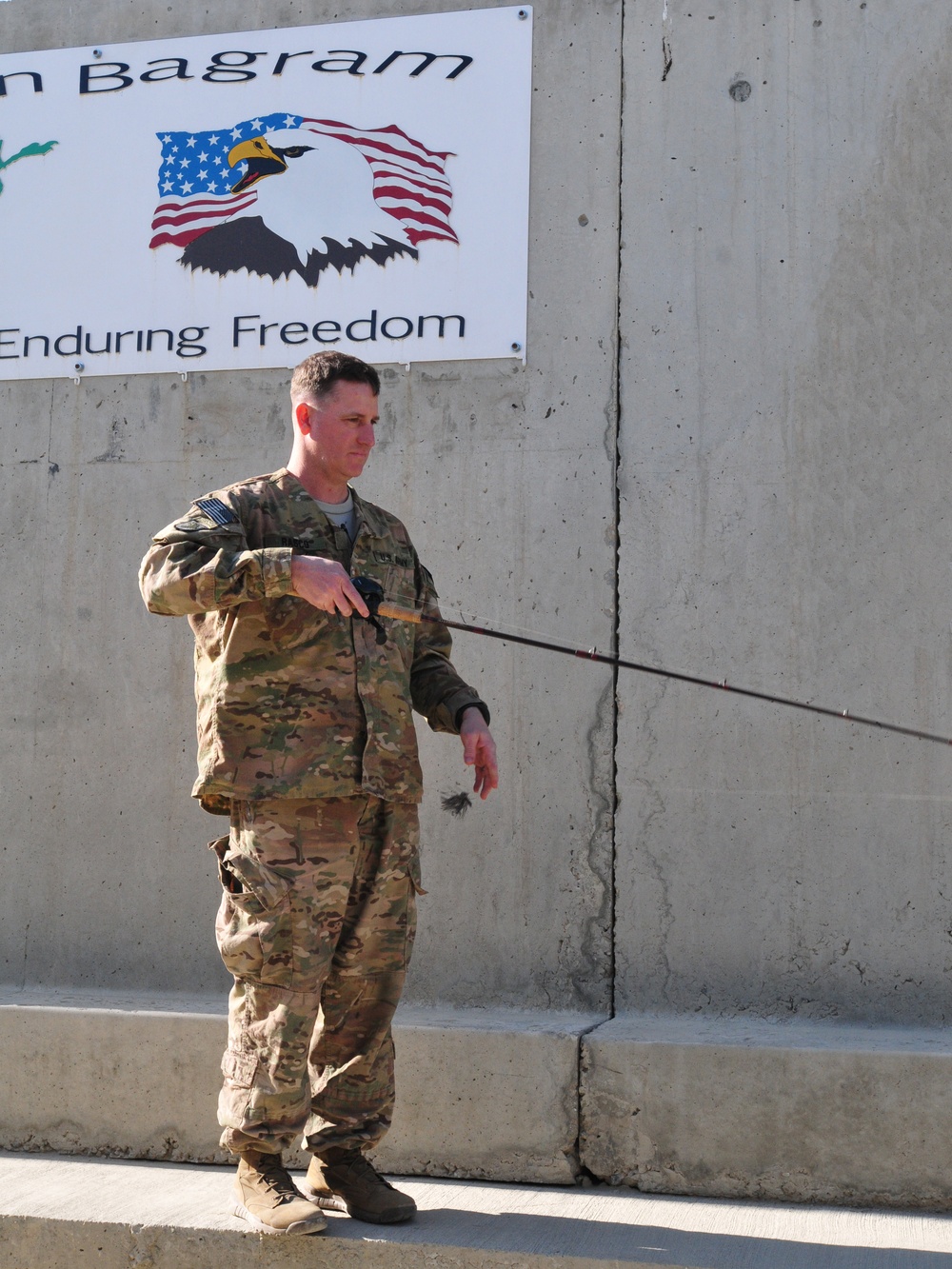 Maj. Mike Rasco practices his flipping casting technique in Bagram Airfield, Afghanistan