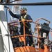 Sailor paints crash and salvage crane