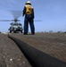 sailors prepare to launch an MH-60R Seahawk