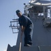 USS Roosevelt sailor cleans deck