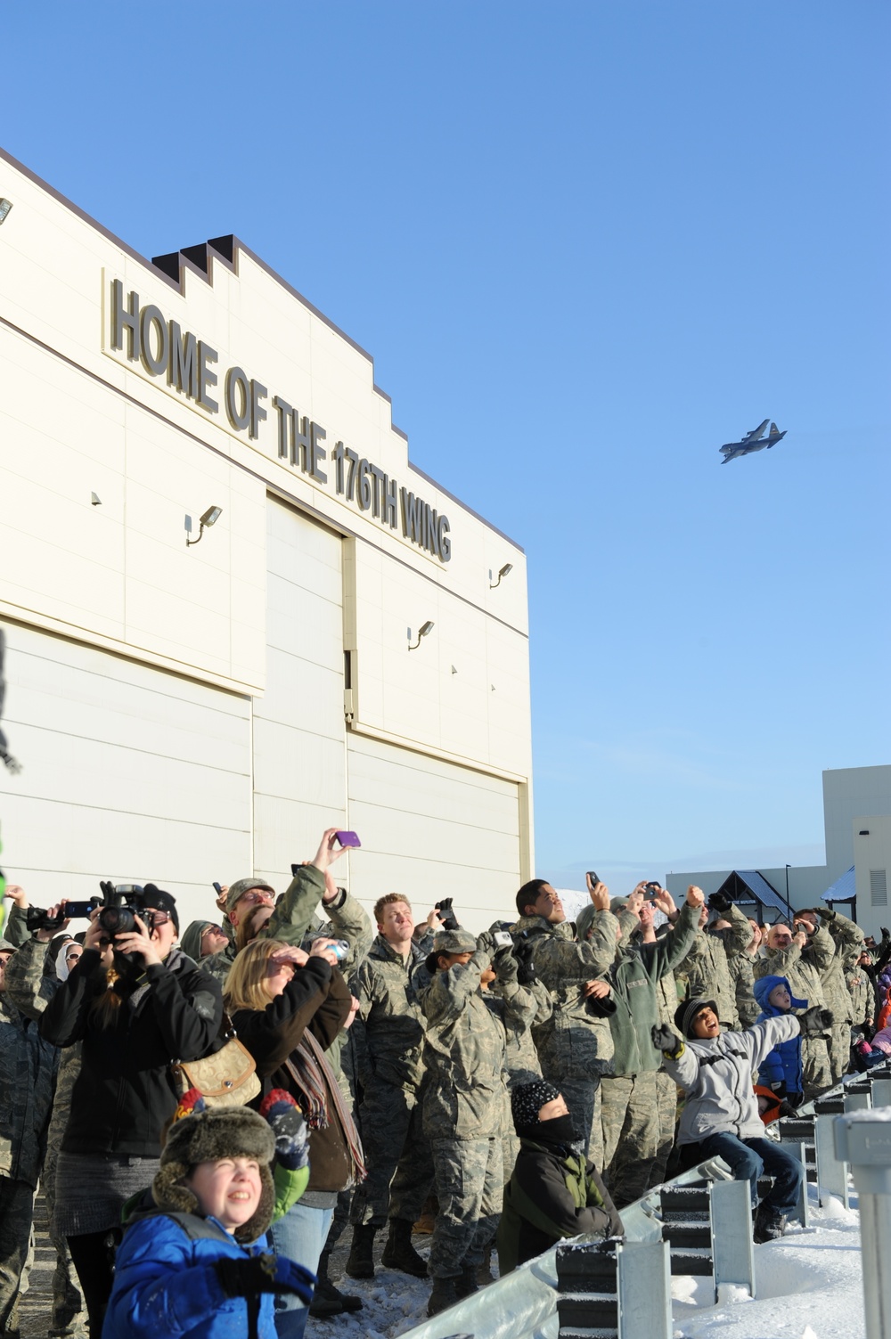 A C-130 flies over the ramp on Joint Base Elmendorf-Richardson