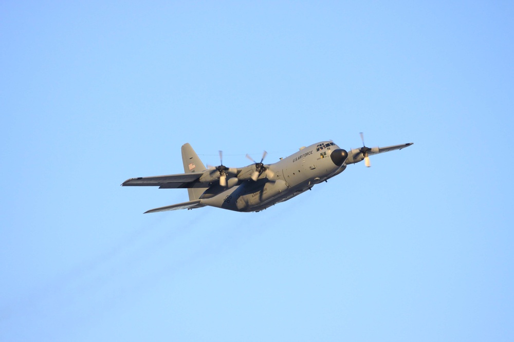 C-130 flies over base