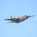 C-130 flies over base