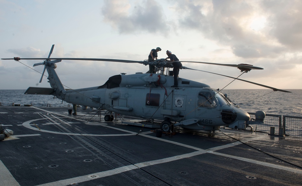 Sailors wash Seahawk aboard USS Halyburton