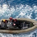 Sailors man rigid-hull inflatable boat after launching from USS Philippine Sea