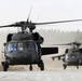 Two US Army UH-60 Black Hawk helicopters prepare to load soldiers
