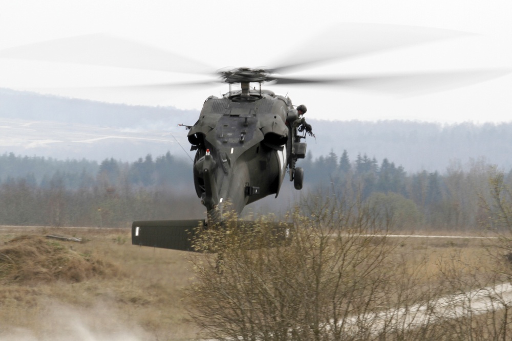 U.S. Army UH-60 Black Hawk helicopter lands to pick up soldiers
