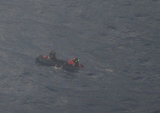 Pararescuemen on Zodiac boat on rescue mission of ill child on the vessel the Rebel Heart
