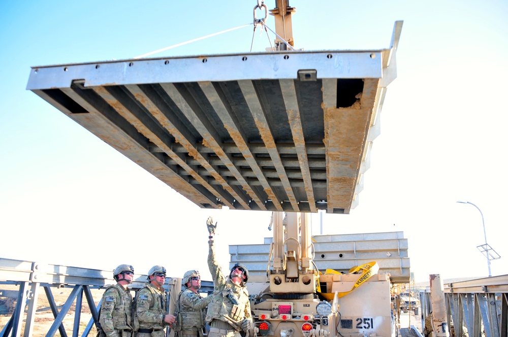 Soldiers from the 1438th Multi-Role Bridging Company repair a bridge on one of their last missions in Afghanistan