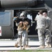Carrying Beny off the medevac helicopter