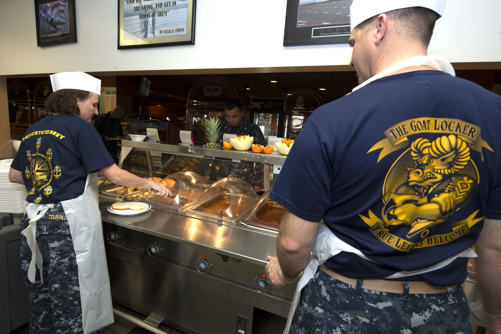 Chief petty officers volunteer their time to serve lunch to sailors at the Naval Station Norfolk base galley