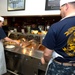 Chief petty officers volunteer their time to serve lunch to sailors at the Naval Station Norfolk base galley