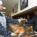 Chief petty officers volunteer their time to serve lunch to sailors at the Naval Station Norfolk base galley