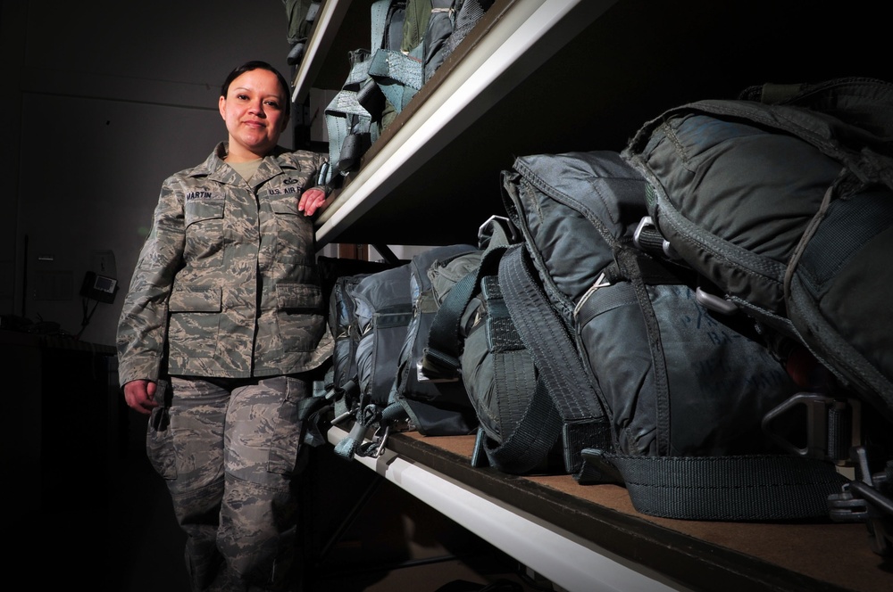 AFE female packs parachutes to save lives