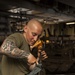 LAR Marines clean machine guns aboard USS Bataan