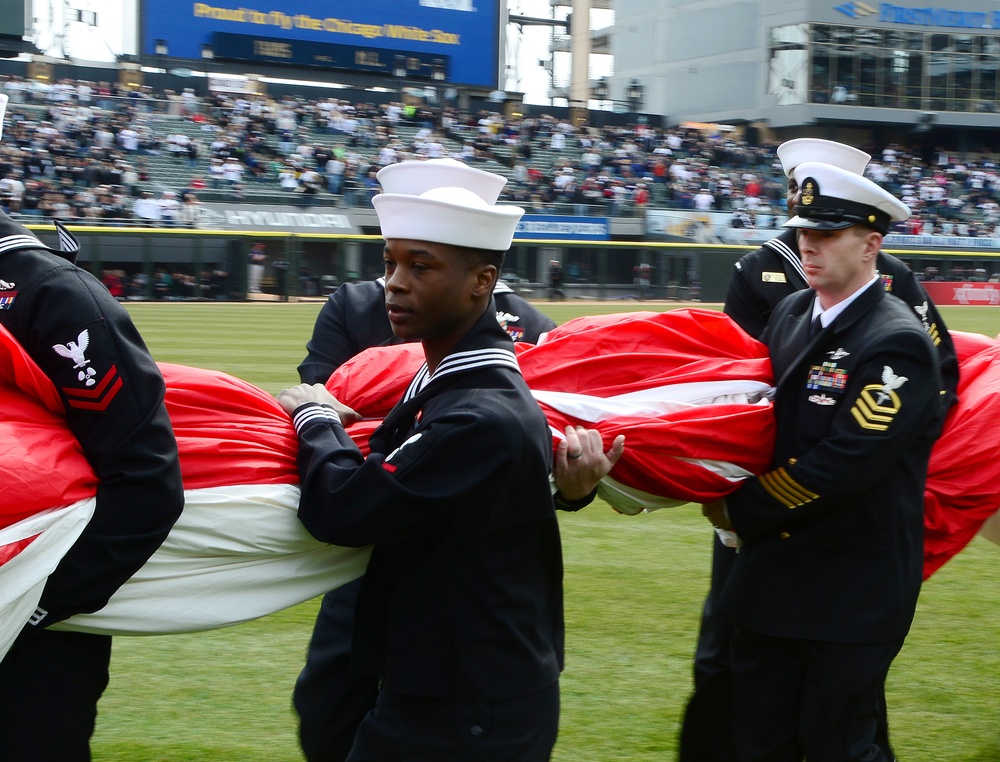Sailors hold American flag for Chicago White Sox opening game
