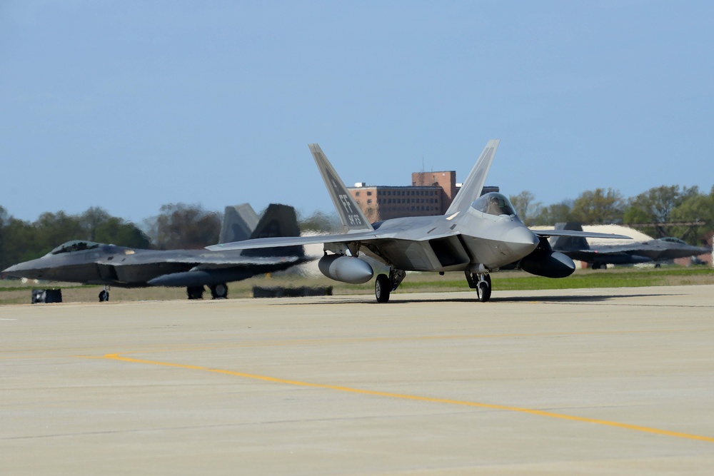 94th Fighter Squadron Airmen, F-22s return from Japan