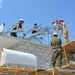 Engineers construct roof at Yorke school construction site in Belize City