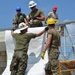 Engineers construct roof at Yorke school construction site in Belize City