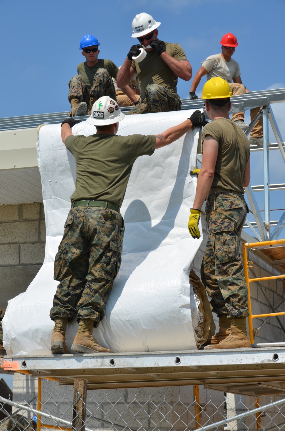 Engineers construct roof at Yorke school construction site in Belize City