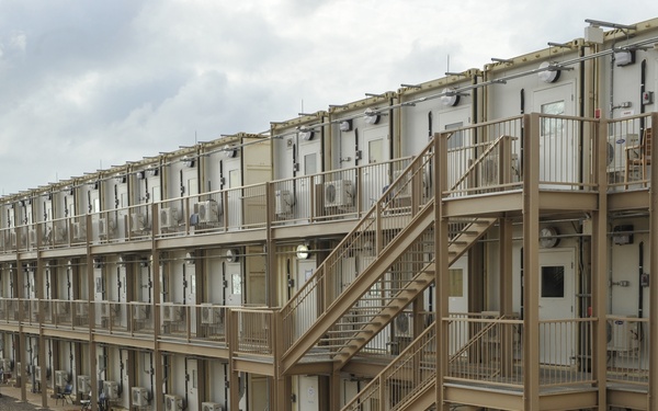 US airman walks towards a housing area composed of containerized living units at Camp Lemonnier, Djibouti, March 27, 2014