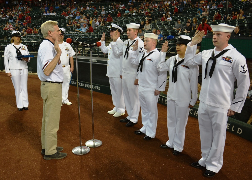 Secretary of the Navy re-enlists Sailors at baseball game