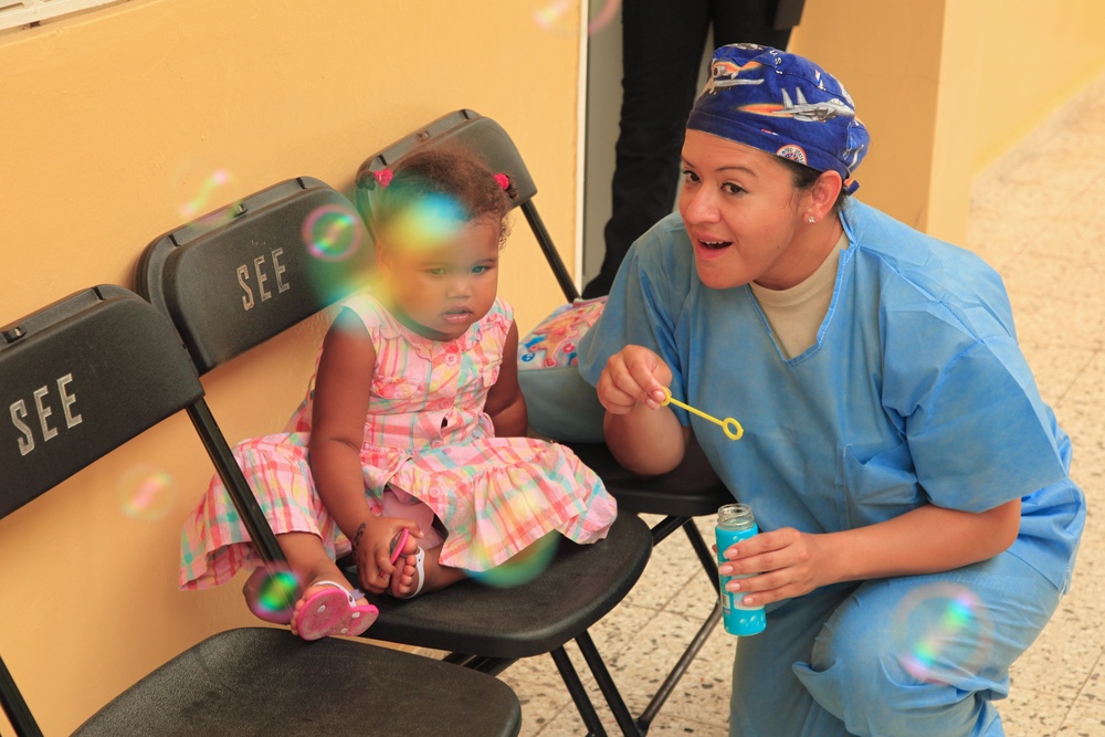Local children of the Dominican Republic wait in line for medical assistance during Beyond the Horizon 2014
