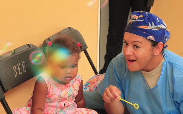 Local children of the Dominican Republic wait in line for medical assistance during Beyond the Horizon 2014