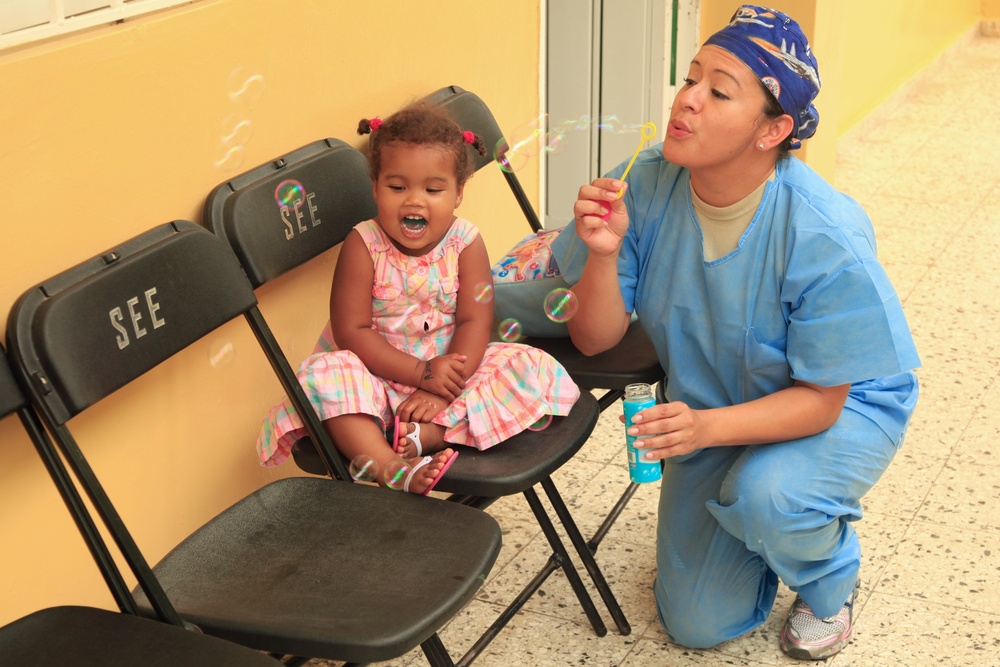Local children of the Dominican Republic wait in line for medical assistance during Beyond the Horizon 2014