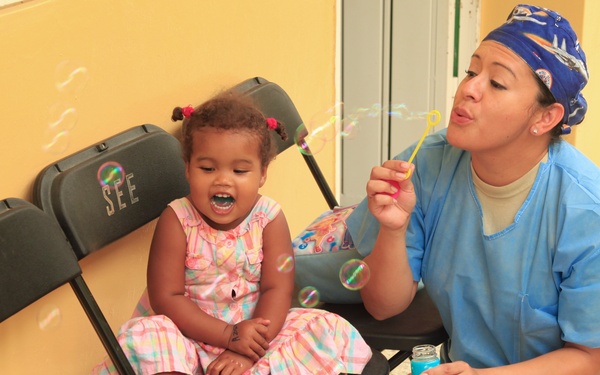 Local children of the Dominican Republic wait in line for medical assistance during Beyond the Horizon 2014