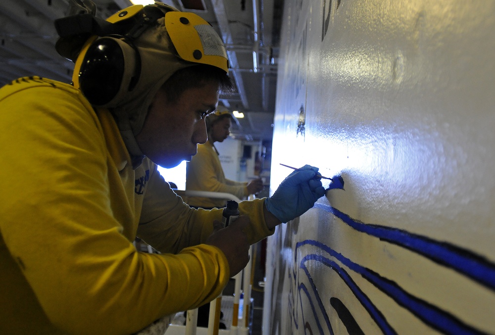 USS Peleliu aviation boatswain's mates paint wings