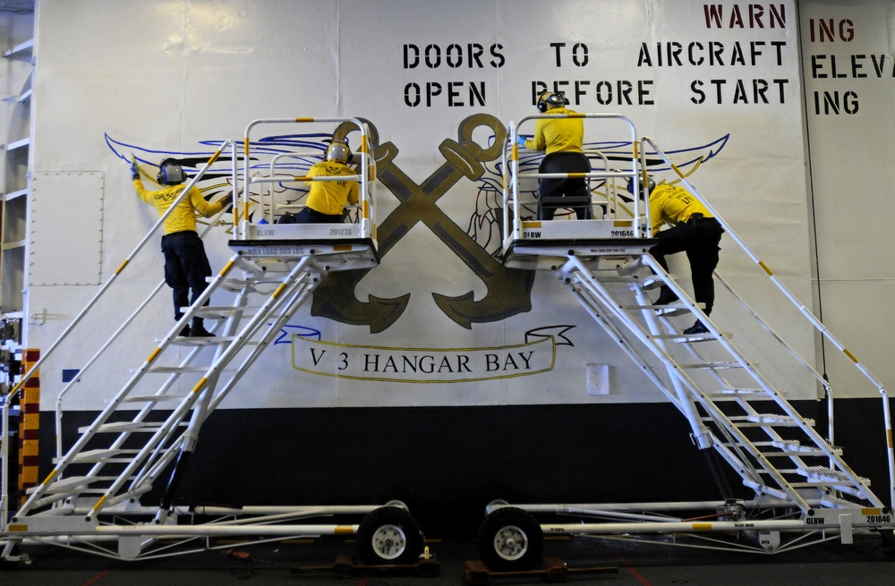 USS Peleliu aviation boatswain's mates paint wings