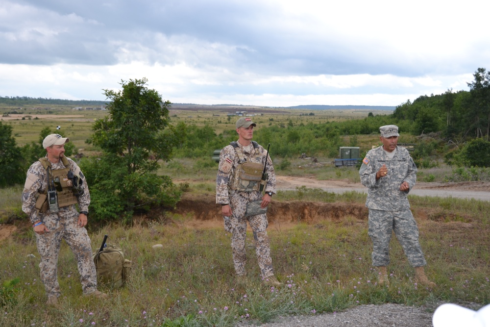 Michigan National Guard Adjutant General briefs with Latvian JTAC team members at Camp Grayling airfield
