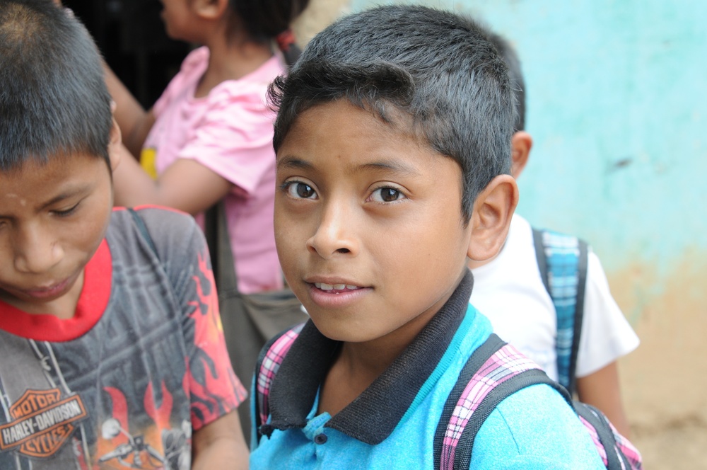 A Guatemalan boy smiles as US service members tour his current school at El Roble during Beyond the Horizon 2014 on April 7