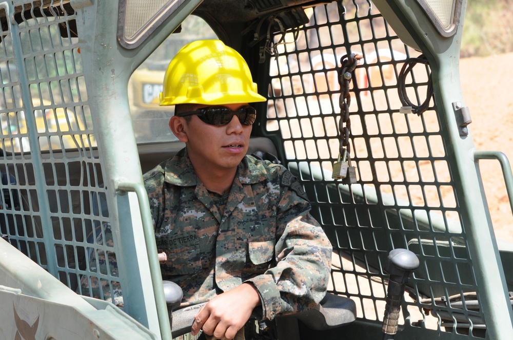 A Guatemalan engineer operates heavy equipment after training with U.S. Air Force engineers at the new school worksite at El Roble during Beyond the Horizon 2014 on April 10