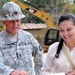 Susana Evangelina Paiz Gonzalez, the school director, smiles after Sgt. 1st Class Timothy Brittain, an engineer with the 35th Engineer Brigade, Missouri Army National Guard informs her that the new school will be finished by the end of June 2014