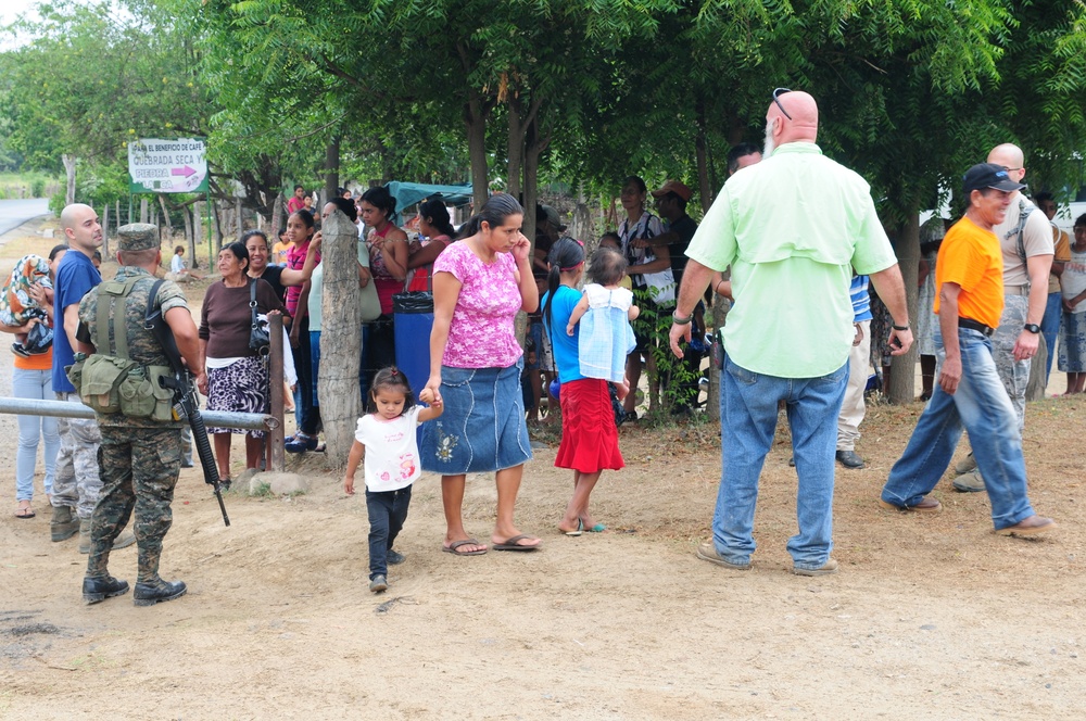 John Henry, a medical planner from 42nd Aeromedical Squadron, directs patients to the triage station during a Medical Readiness Training Exercise at Caseria Los Limones in Zacapa, Guatemala during Operation Beyond the Horizon April 21, 2014