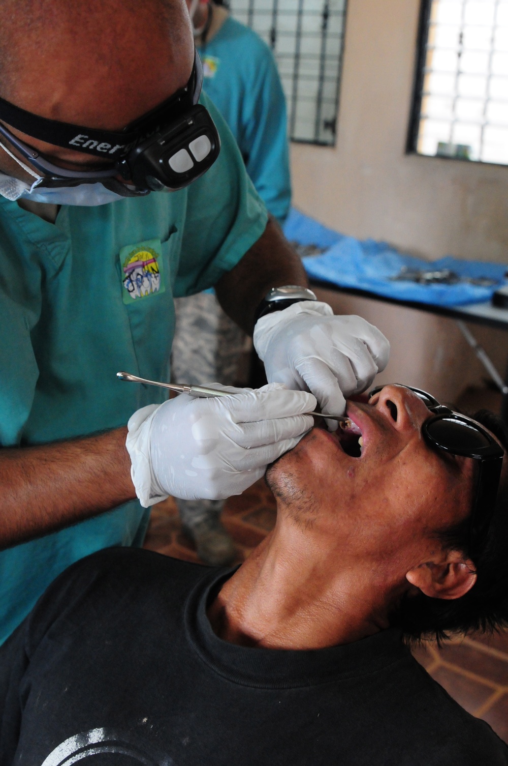 Air Force Capt. John Mallya, a dentist with the 22nd Aeromedical Squadron prepares a tooth for extraction at the dental clinic portion of the Medical Readiness Training Exercise in Zacapa, Guatemala April 21, 2014