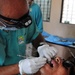 Air Force Capt. John Mallya, a dentist with the 22nd Aeromedical Squadron prepares a tooth for extraction at the dental clinic portion of the Medical Readiness Training Exercise in Zacapa, Guatemala April 21, 2014