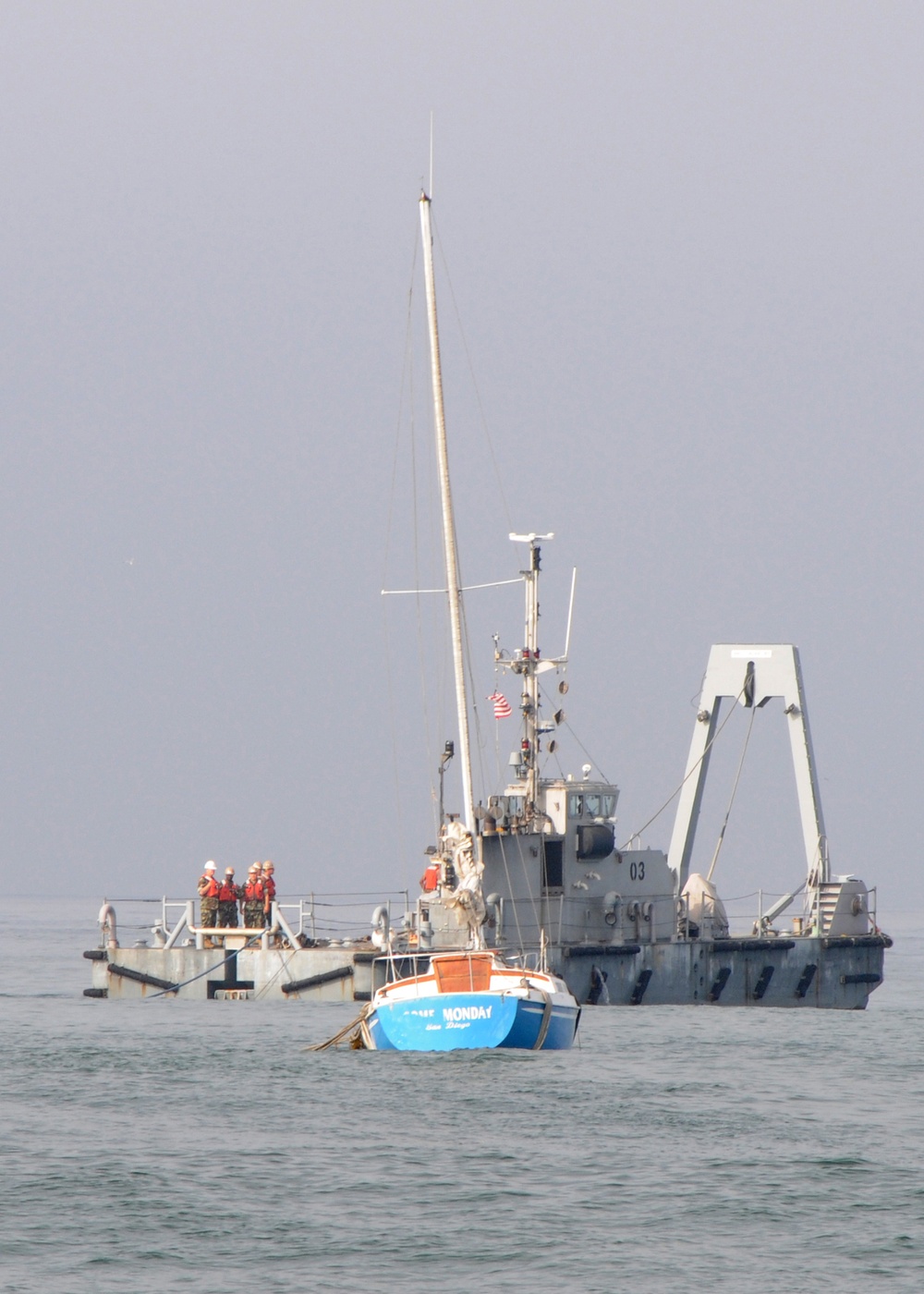 Beached sailboat towed