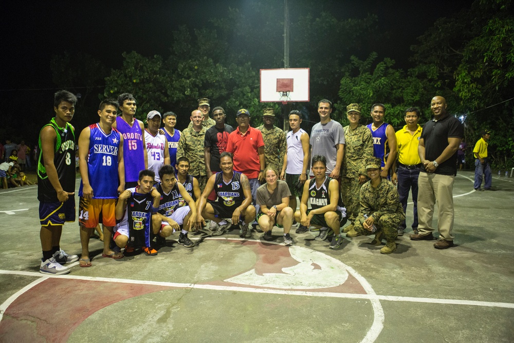 AFP service members, local residents of Barangay Bigaa and U.S. service members participate in a friendship basketball game