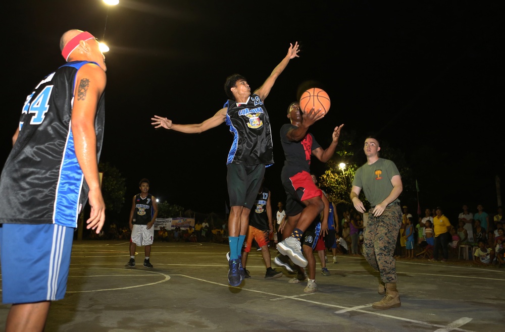 AFP service members, local residents of Barangay Bigaa and U.S. service members participate in a friendship basketball game