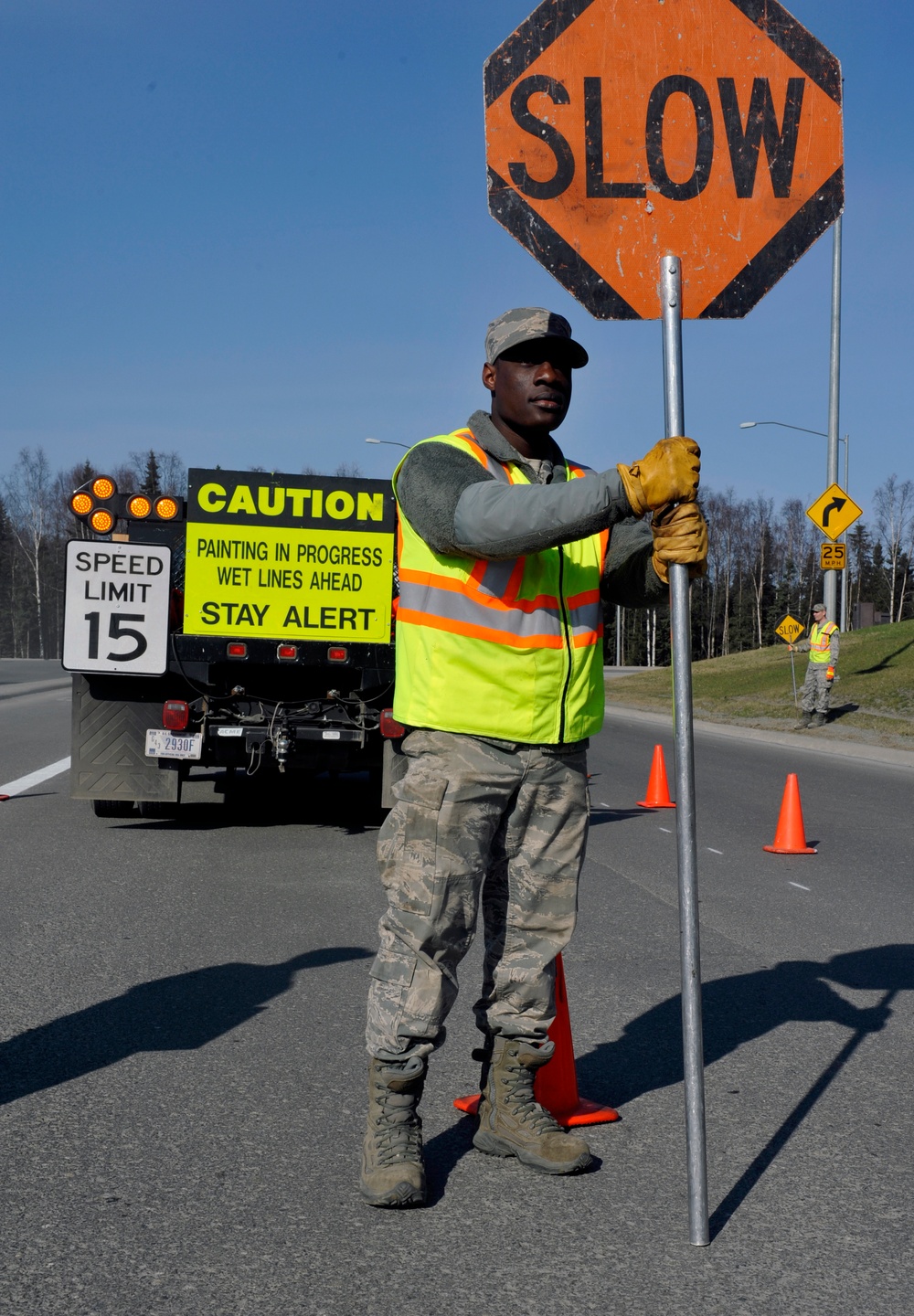 Civil engineers repaint road lines, patch potholes