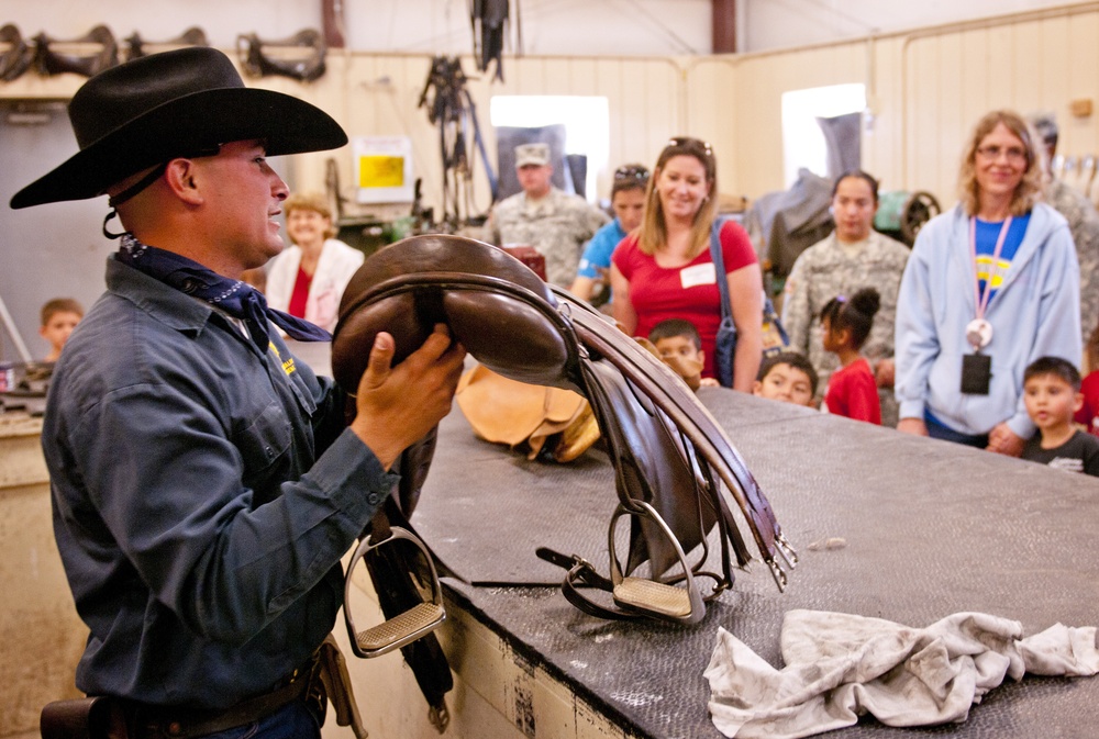 Horse Cavalry Detachment Soldier shows kids how saddles are made