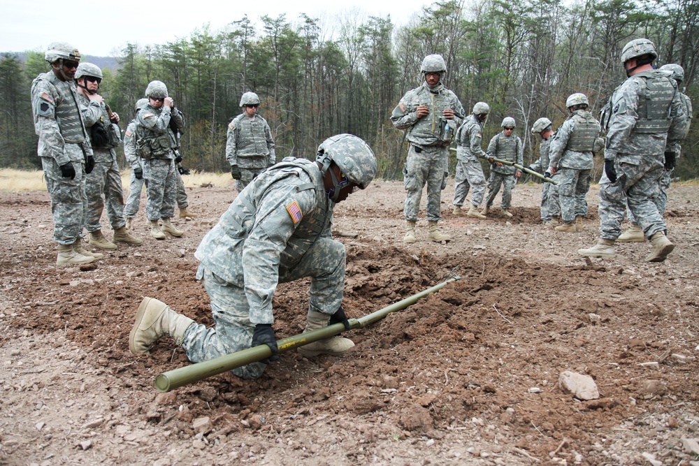 A soldier lays pipe before the explosion