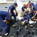 Coast Guard Cutter Paul Clark crew members offloads contraband