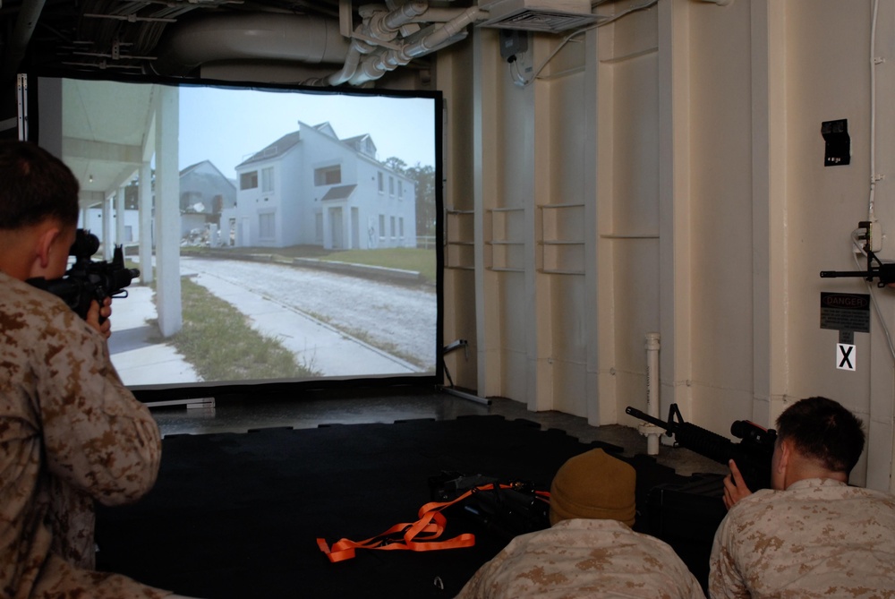 Combat Logistics Battalion 24 Marines use Indoor Simulated Marksmanship Trainer aboard USS Mesa Verde